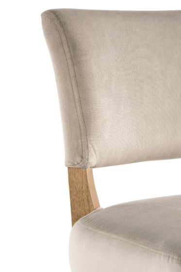 A stylish bar stool with a soft grey velvet seat and back featuring delicate studding detail.